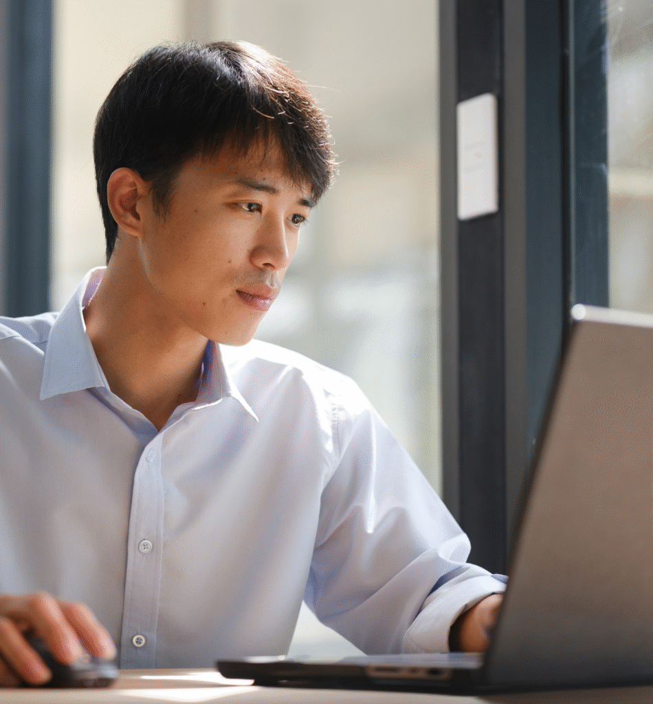 Image Business consultant analyzing financial data on a laptop
